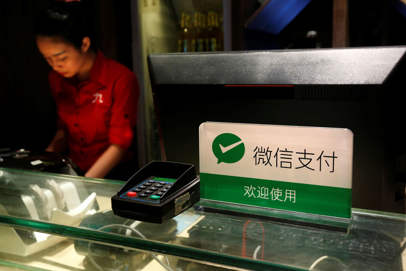 © Reuters. A notice accepting WeChat Pay is displayed at the cashier inside a restaurant in Guangzhou
