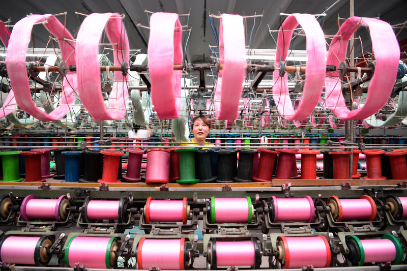 © Reuters. An employee works at a silk factory in Nantong