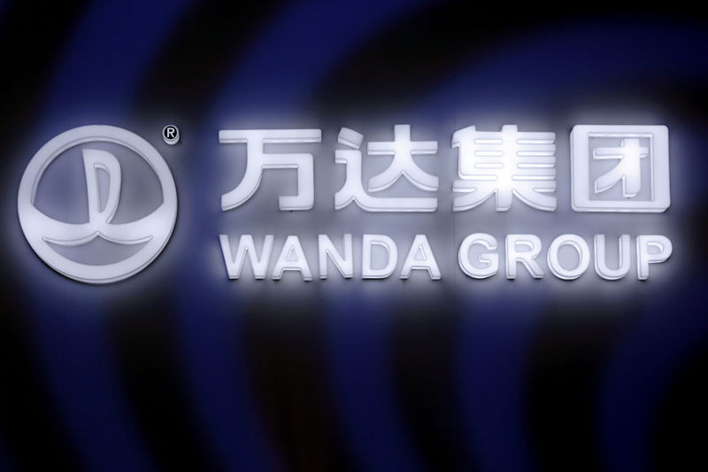 © Reuters. FILE PHOTO: A sign of Dalian Wanda Group in China glows during an event in Beijing