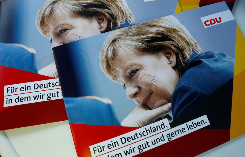 © Reuters. Brochures, showing German Chancellor Merkel, top candidate of the Christian Democratic Union Party (CDU) are seen during an election rally for the upcoming federal elections in Gelnhausen