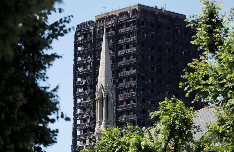 © Reuters. FILE PHOTO: The spire of the Notting Hill Methodist Church stands in front of Grenfell Tower, destroyed in a catastrophic fire, in the Royal Borough of Kensington and Chelsea, in London