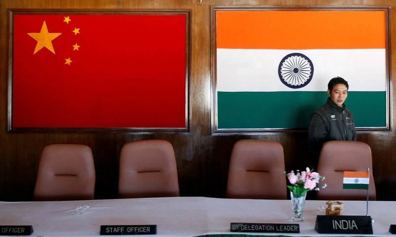 © Reuters. FILE PHOTO: A man walks inside a conference room used for meetings between military commanders of China and India, at the Indian side of the Indo-China border at Bumla