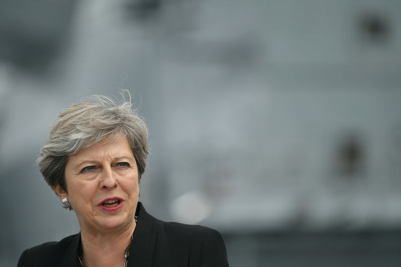 © Reuters. FILE PHOTO: Britain's Prime Minister Theresa May stands on the flight deck as she speaks to crew members of the British aircraft carrier HMS Queen Elizabeth, during her tour of the ship, after it arrived at Portsmouth Naval base, its new home port, in Portsmouth