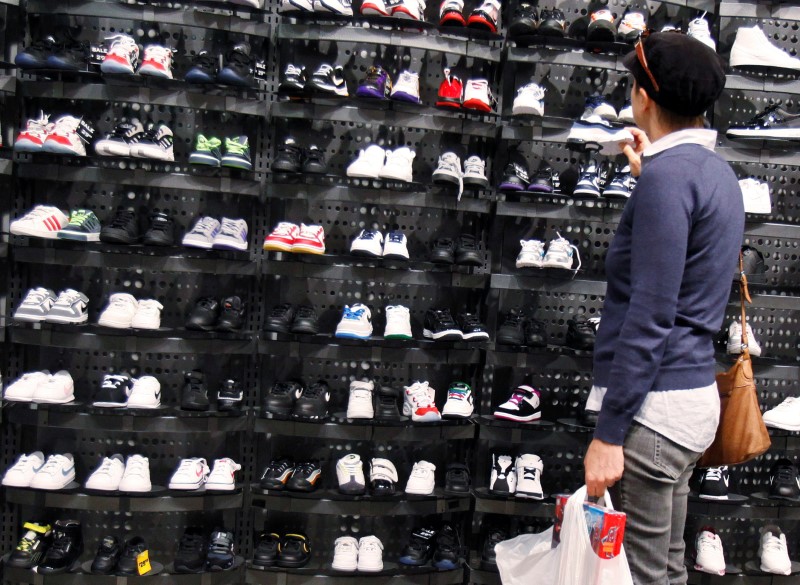 © Reuters. A woman shops inside a Foot Locker store in New York