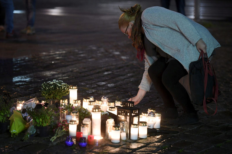 © Reuters. Candles at Turku Market Square for the victims of Friday's stabbings are pictured in Turku