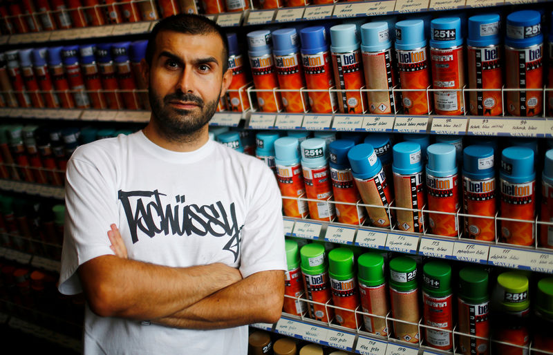 © Reuters. Graffiti artist Omari poses for a portrait in his shop in Berlin