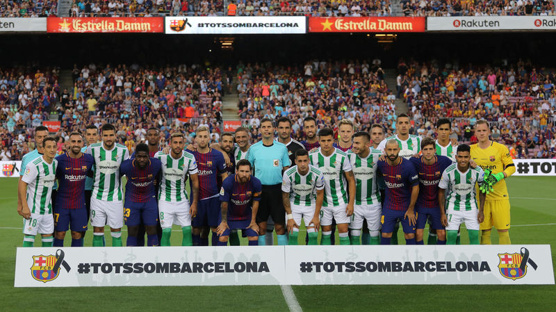 © Reuters. Los jugadores de Barcelona y Betis posan antes de comenzar el partido entre ambos equipos por la liga española de fútbol