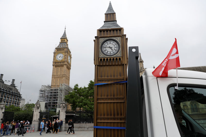 © Reuters. The Sun newspaper drive a model of the 'Big Ben' on the back of a truck equipped with loudspeakers around parliament square in London