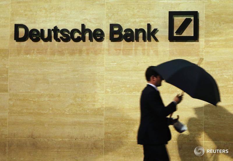 © Reuters. A man walks past Deutsche Bank offices in London