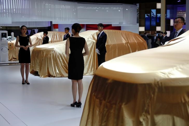 © Reuters. Vehicles seen covered at WEY booth at auto show in Shanghai