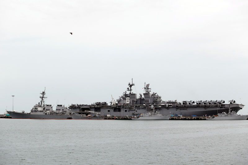 © Reuters. The damaged USS John McCain and the USS America are docked at Changi Naval Base in Singapore