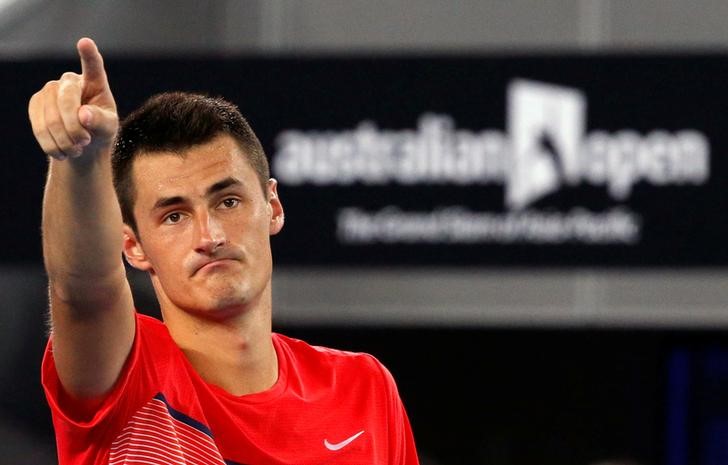 © Reuters. FILE PHOTO - Australia's Bernard Tomic celebrates after winning his second round match against Italy's Simone Bolelli at the Australian Open tennis tournament at Melbourne Park,