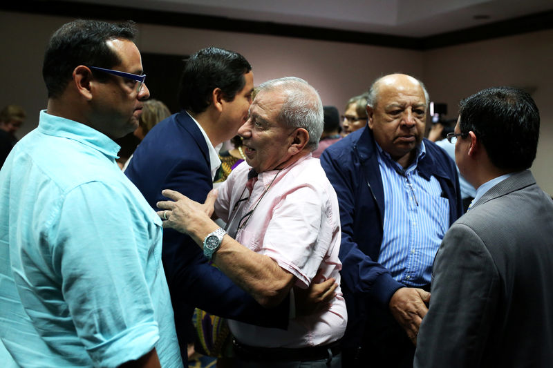 © Reuters. Relatives of former Salvadoran army officers embrace after news that the Supreme Court suspended arrest warrants against soldiers for their alleged involvement in the 1989 massacre of Jesuit priests during the civil war, in San Salvador