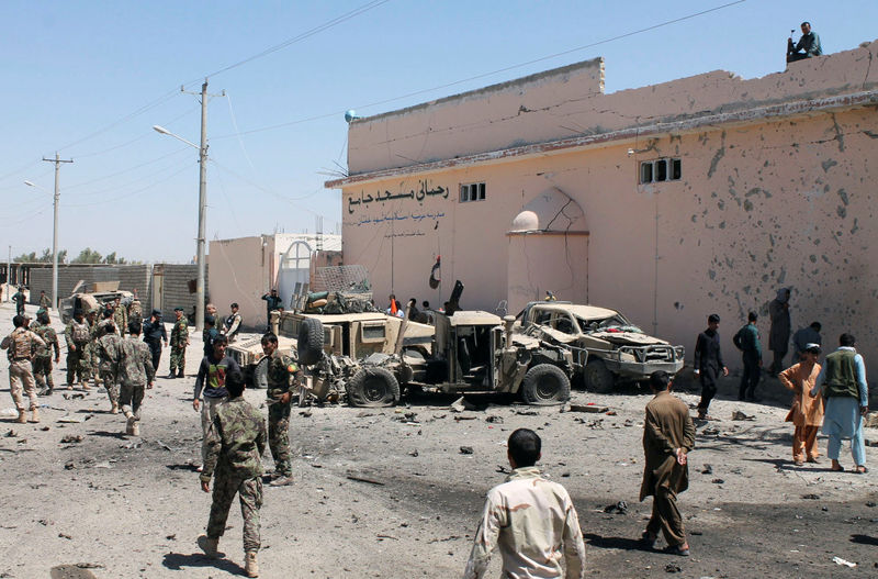 © Reuters. Afghan National Army (ANA) soldiers inspect damaged army vehicles after a suicide attack in Lashkar Gah, Helmand province, Afghanistan