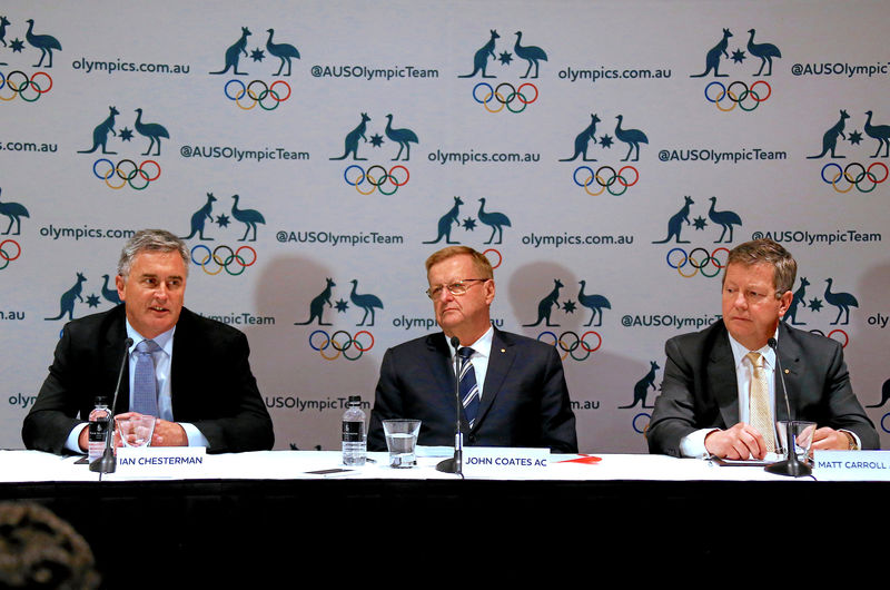 © Reuters. John Coates, President of the Australian Olympic Committee, and Matt Carroll, AOC's Chief Executive Officer, listen to Ian Chesterman, Australia's chef de mission for the 2020 Tokyo Olympic Games, as he speaks during a media conference in Sydney