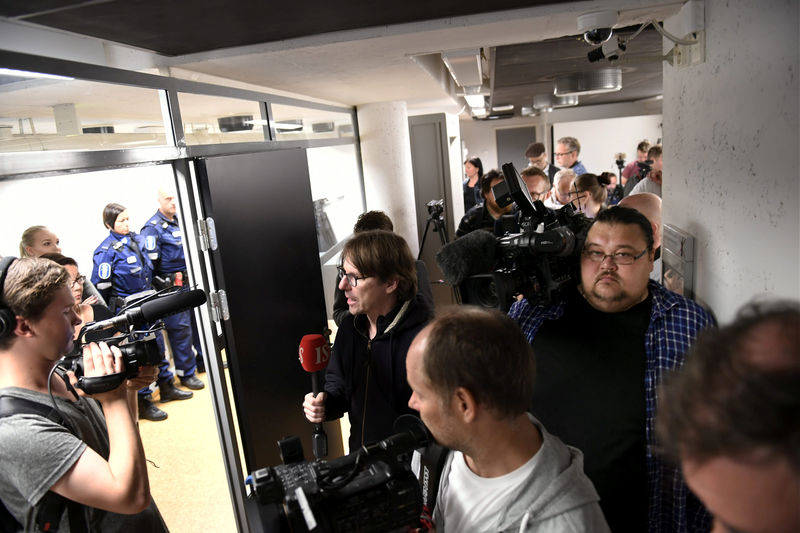 © Reuters. FILE PHOTO: Press and and police pictured before the initial remand hearing of Abderrahman Mechkah in Turku