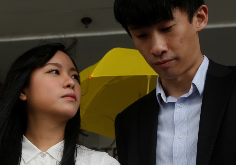 © Reuters. Disqualified pro-independence legislators Yau Wai-ching and Baggio Leung react outside a court in Hong Kong