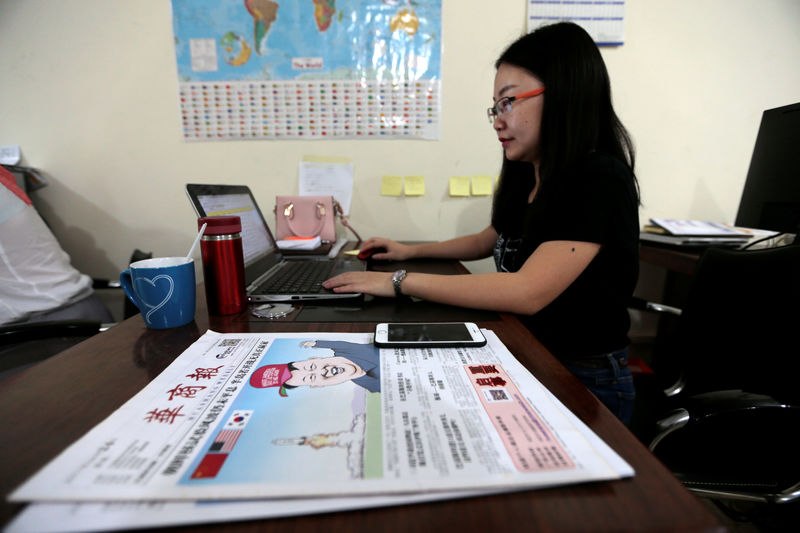 © Reuters. Rama, Editor in Chief of  Hushang a Mandarin language weekly newspaper, works at her office in Islamabad