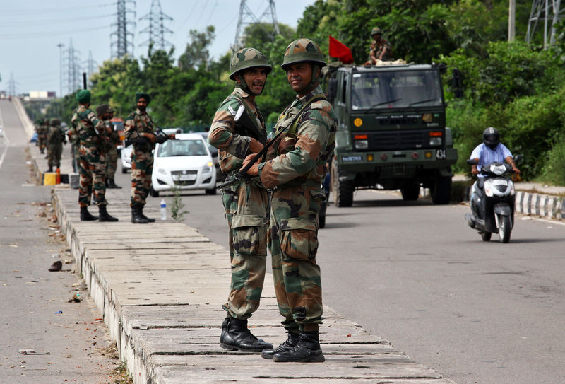 © Reuters. Soldiers stand guard at a highway in Panchkula