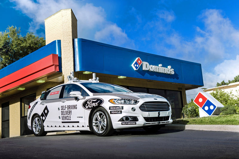 © Reuters. A Ford self-driving delivery vehicle is pictured in front of a Domino's pizza restaurant in this handout photo