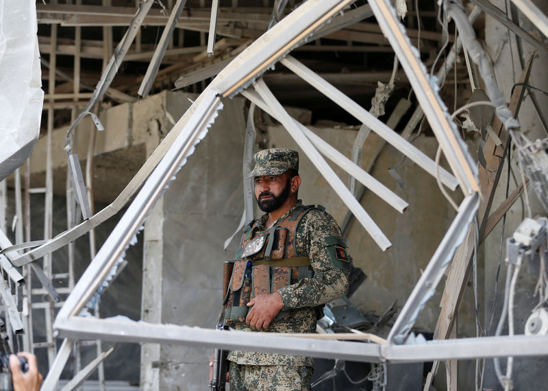 © Reuters. An Afghan security force stands guard at the site of a suicide bomb attack in Kabul