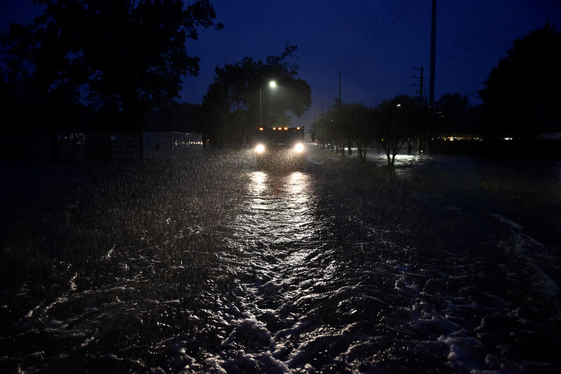 © Reuters. A civilian owned military vehicle drives through floodwaters performing search and rescue after Hurricane Harvey inundated the Texas Gulf coast with rain causing widespread flooding, in Houston