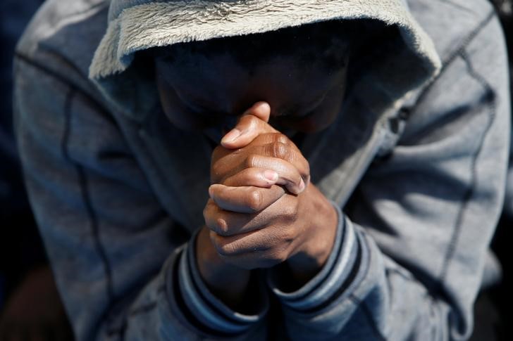 © Reuters. A migrant prays on the Migrant Offshore Aid Station ship Topaz Responder after being rescued around 20 nautical miles off the coast of Libya