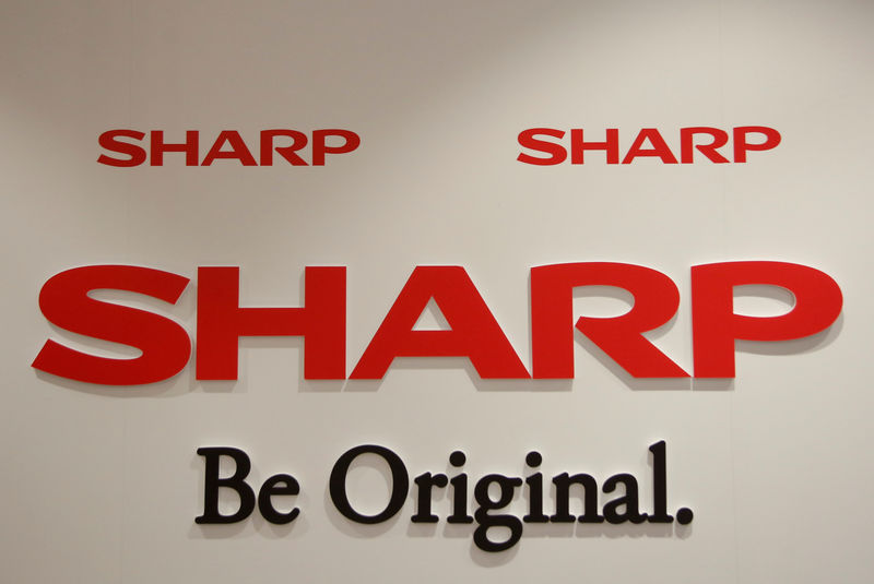 © Reuters. Logos of Sharp are seen during a news conference to reflect on its first year's progress, after electronics manufacturer Foxconn's major investment into the company, in Taipei