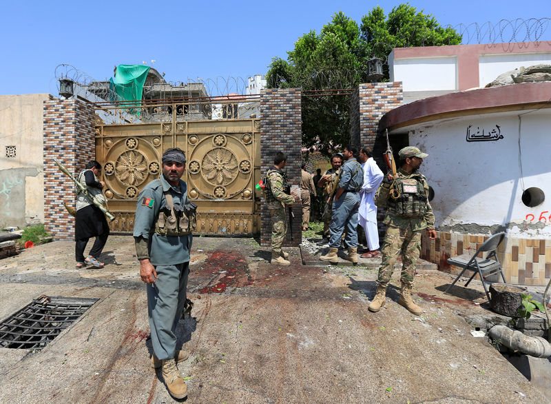 © Reuters. Afghan security force stand at the site of a suicide attack in Jalalabad city