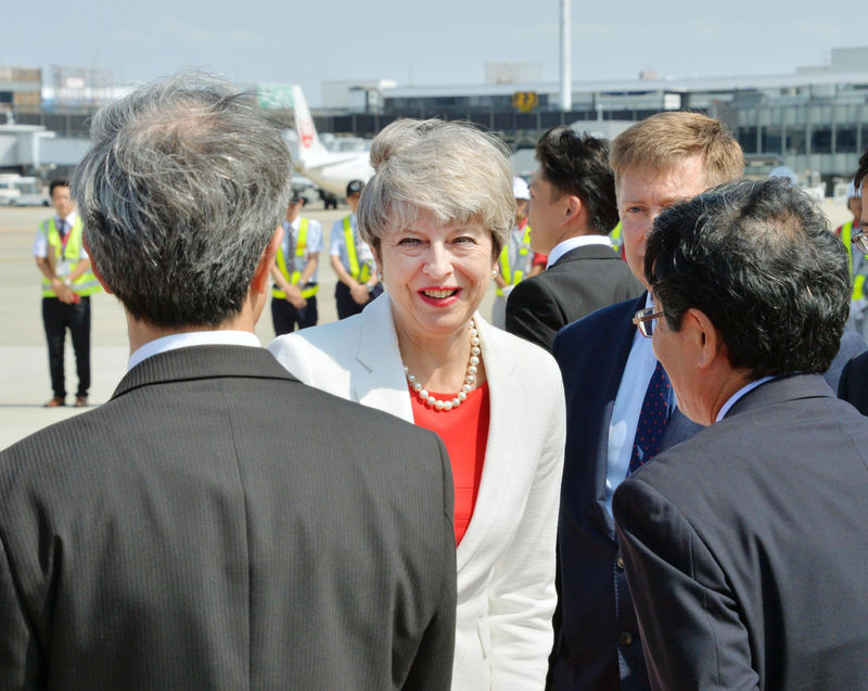 © Reuters. Britain's Prime Minister Theresa May is welcomed by officials upon her arrival at Itami airport in Osaka, western Japan