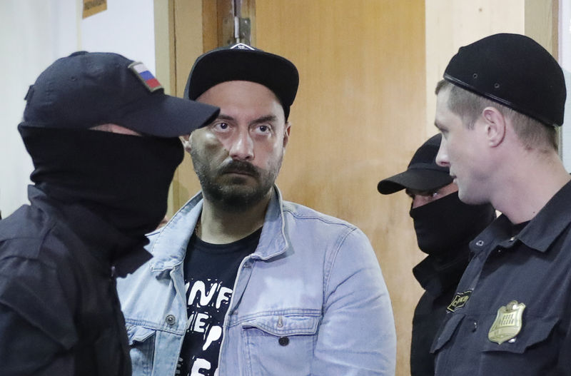 © Reuters. Russian theatre director Serebrennikov is escorted inside a court building in Moscow