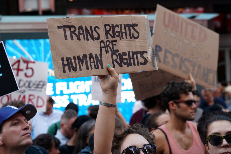 © Reuters. FILE PHOTO: People protest Trump's announcement that he plans to reinstate a ban on transgender individuals from serving in any capacity in the U.S. military, in Times Square