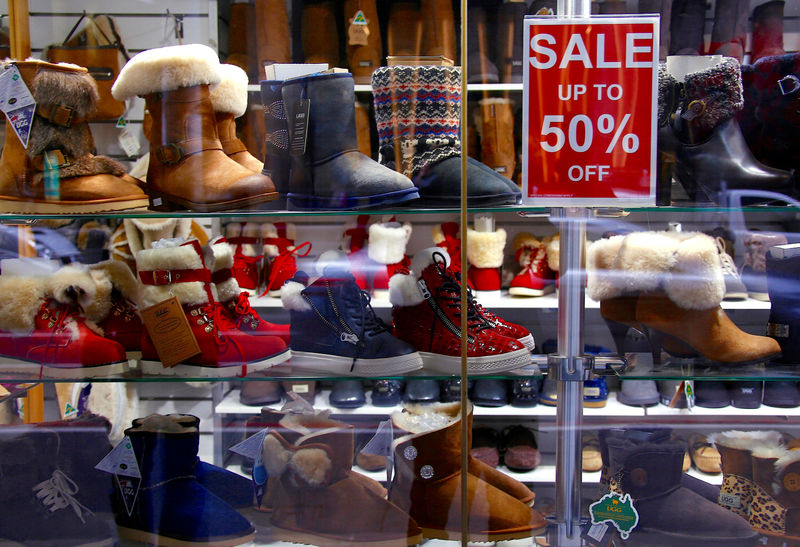 © Reuters. Shoes lined with wool known as 'Ugg' boots are displayed behind a sales sign in the window of a retail store in central Sydney, Australia