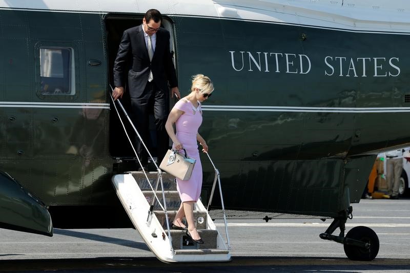 © Reuters. FILE PHOTO: Mnuchin and Linton arrive aboard the deck of the aircraft carrier USS Gerald R. Ford for its commissioning ceremony at Naval Station Norfolk in Norfolk, Virginia