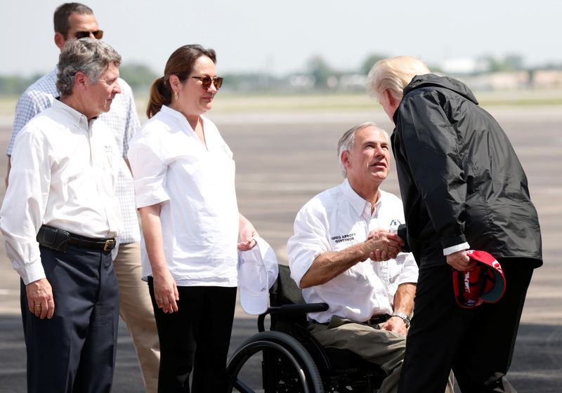 © Reuters. U.S. President Donald Trump greets Texas Governor Greg Abbott after arriving at Ellington Field to meet with flood survivors and volunteers who assisted in relief efforts in the aftermath of Hurricane Harvey, in Houston