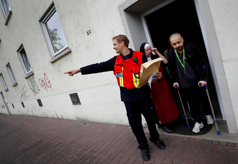 © Reuters. Un funcionario local dirige la evacuación de un asilo para persons sin hogar en Fráncfort, Alemania.