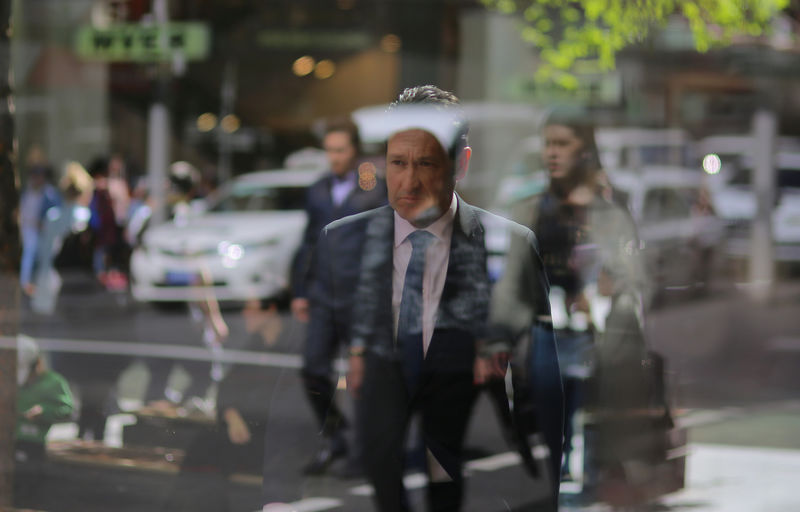 © Reuters. A businessman walks the streets of Sydney, Australia