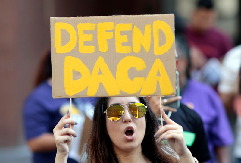 © Reuters. FILE PHOTO: Yessenia Lopez stands with supporters of the DACA program recipient during a rally outside the Federal Building in Los Angeles