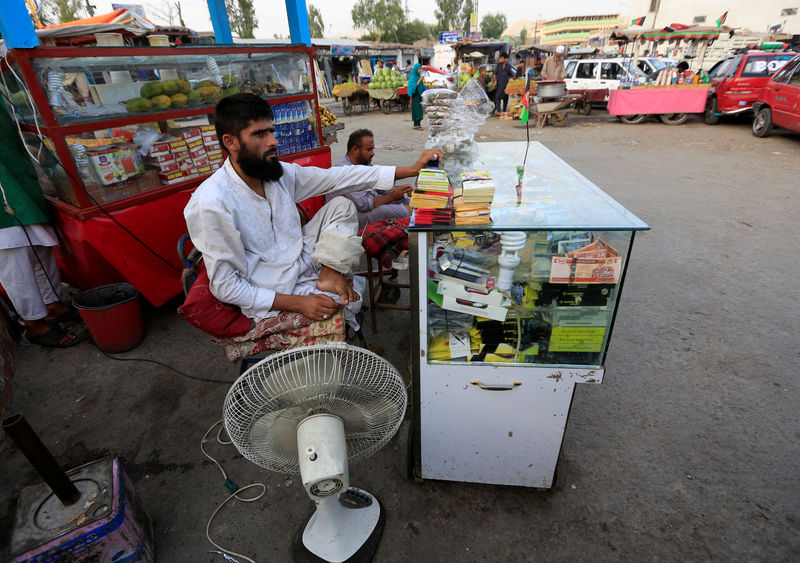 © Reuters. Mehrullah Safi, 28, a disabled Afghan National Army (ANA) soldier, sells mobile phone cards in Jalalabad province