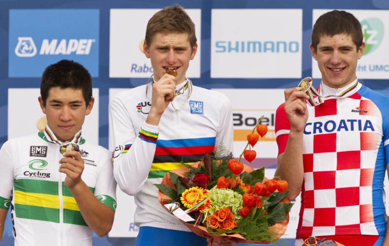 © Reuters. Mohoric, Ewan and Rumac show their medals on the podium after the Men's Junior Road Race at the UCI Road World Championships in Valkenburg