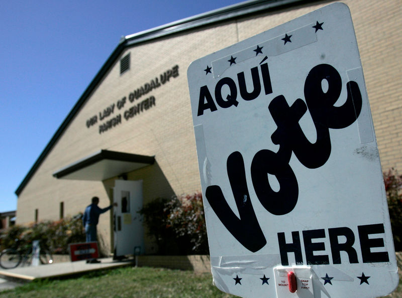 © Reuters. FILE PHOTO: A voter enters a polling station to cast his vote in the Texas Primary in Seguin