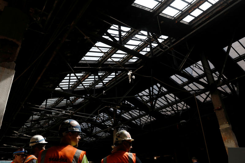 © Reuters. Construction workers are seen at The Moynihan Train Hall in New York