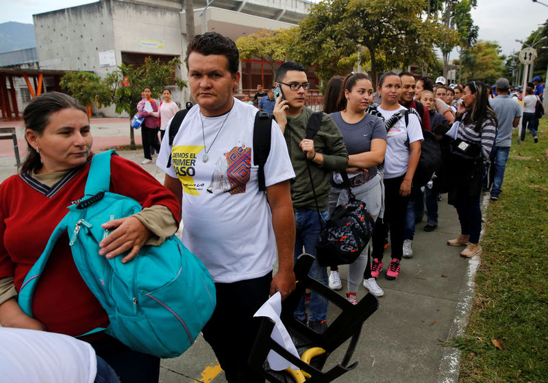 © Reuters. The faithful arrive for a holy mass on Saturday by Pope Francis at Olaya Herrera Airport, Medellin