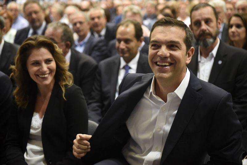 © Reuters. Greek PM Tsipras and his partner Betty Batziana smile as they attend the opening of the annual International Trade Fair of Thessaloniki, in Thessaloniki