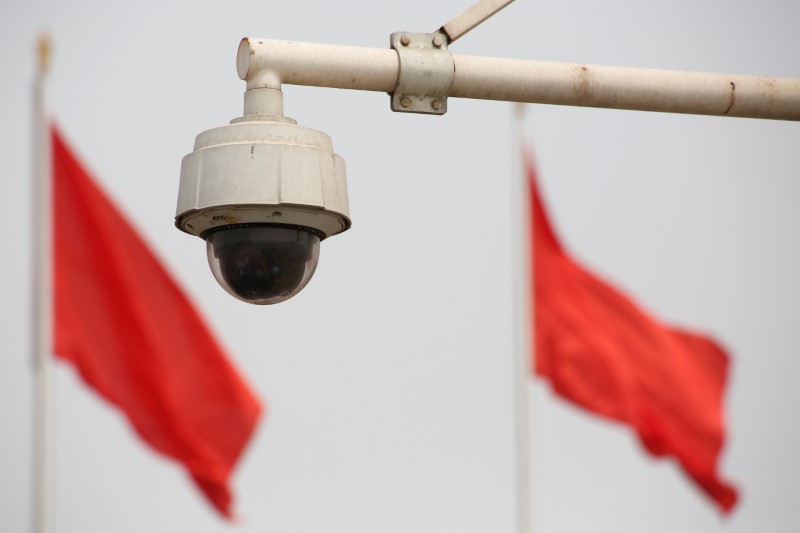 © Reuters. FILE PHOTO: Red flags fly near a security camera on Beijing's Tiananmen Square