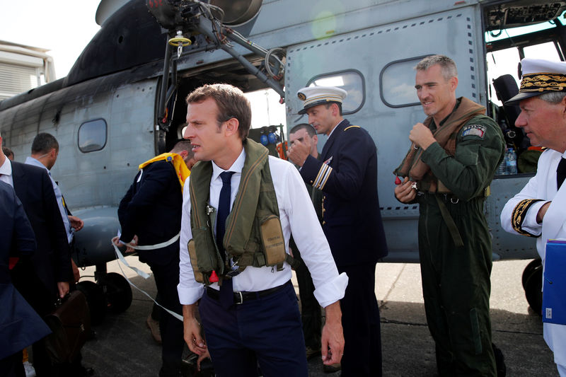 © Reuters. France's President Emmanuel Macron waits on the tarmac of Pointe-a-Pitre airport, Guadeloupe island, before boarding an helicopter en route to French Caribbean islands of St. Martin and St. Barthelemy