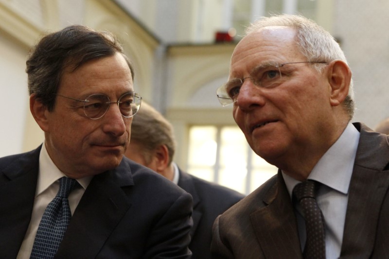 © Reuters. German Finance Minister Schaeuble listens to ECB President Draghi during a discussion in Berlin