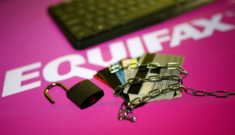 © Reuters. Credit cards, a chain and an open padlock is seen in front of displayed Equifax logo in this illustration