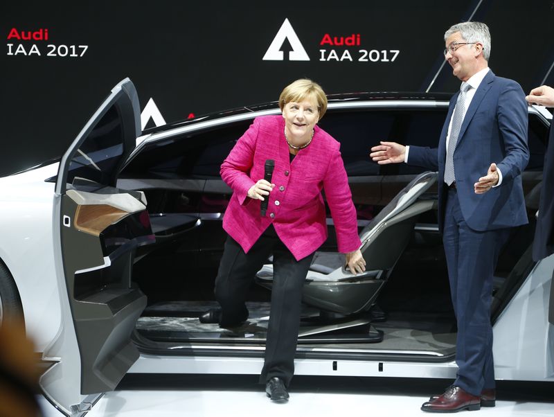 © Reuters. German chancellor Angela Merkel sits in an Audi Aicon next to Audi CEO Stadler during the opening of the Frankfurt Motor Show