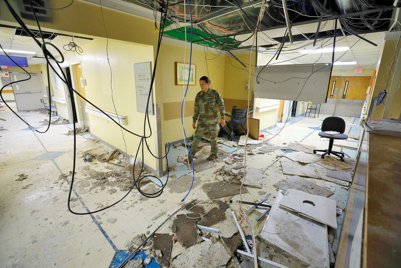 © Reuters. Angela Carlson walks through a destroyed section of Schneider Regional Medical Center while searching for usable materials in the U.S. Virgin Island's main hospital, in Charlotte Amalie